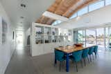 The dining room is separated from the living area by a built-in cabinet, both rooms are located under the home's airy vaulted ceiling. 