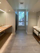 The bunk room bathroom was designed to support large parties. A large counter and plentiful open shelves and hooks provide parties of all sizes space to stow their personal items.