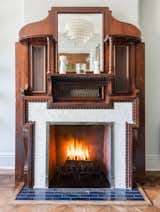 Working marble and wood fireplace with intricate detailing.
