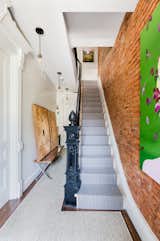 Stairs in the owner's triplex lead up to 4 bedrooms and 3 bathrooms.