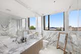The spa-like master en-suite is marble-clad with a relaxing soaking tub.