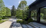 Outdoor, Walkways, Large Patio, Porch, Deck, Trees, Back Yard, and Hardscapes Broadview Guest House featuring yakisugi (shou sugi ban) japanese charred wood siding  Photo 4 of 5 in Broadview Guest House by Nakamoto Forestry