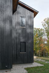 New England Forest House featuring yakisugi (shou sugi ban) japanese charred wood siding