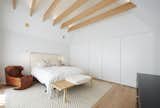 Bedroom, Bench, Bed, Accent Lighting, Light Hardwood Floor, Storage, and Pendant Lighting Principal Bedroom  Photo 3 of 10 in Curvy Eco Home by Craig Race Architecture Inc.