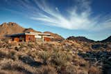 The house is nestled into the foothills, surrounded by wilderness but only 5 minutes from 'downtown' Joshua Tree. 
