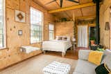 Bedroom, Medium Hardwood Floor, Table Lighting, Storage, Bed, Ceiling Lighting, and Chair Our cabin has 10 foot ceilings which help the space feel big and expansive.   Photo 1 of 11 in Off Grid Cabin in the Texas Hill Country by Marlena Jarjoura