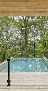 The pool was designed and constructed in a way to appear as floating in the middle of the forest, being suspended 20 feet from the ground. During winter months a clear view over the Adirondack mountains gives a feeling of vastitude. 