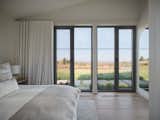 he guest bedroom offers breathtaking views of the surrounding mountains and Lake Brome. Large windows frame the landscape, allowing guests to fully immerse themselves in the tranquil beauty of nature, making it the perfect retreat within the home.