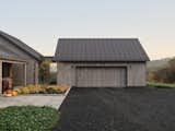 From the garage, the glass walkway extends toward the pasture, offering a picturesque view of grazing cows. This thoughtful design element enhances the connection between the built environment and the rural setting, blending functionality with a serene, immersive experience.