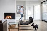 The wall holding the fireplace separates the kitchen from the living room (featuring pup Major). "It's nice to have some separation," says Weber. "In small-space design, you get more for your money by having different experiences, not just one room."