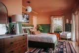 An unusual pairing of pink and deep green find a happy match in this renovated apartment, which was DIY’ed by the homeowner, comedian&nbsp;Mamrie Hart,&nbsp;and her friend Claire Thomas, a creative director. "I am used to painting," says Thomas, "but I was not emotionally prepared for the amount of trim in the bedroom." Cedarville, a pastel pink hue, and Green Bayou, both by Dunn-Edwards Paints, now cheer up the space.