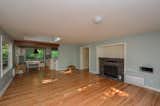 Before: The main living space was large, but cut off from the kitchen by a wall and featured a dated fireplace.  Photo 2 of 21 in Before & After: A Murky Home in Seattle Gets a Huge Dose of Light and Color