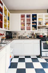 Josephine Heilpern, founder of Brooklyn ceramics studio Recreation Center, revamped her run-down, rent-stabilized apartment in New York’s Crown Heights neighborhood, which had been occupied by the previous tenant for 40 years. In the kitchen, Josephine removed most of the upper-cabinet doors and painted the open shelving with mustard yellow, denim blue, primary red, and a bubblegum-pink color inspired by vintage California homes lined in salmon-colored tiles.&nbsp;