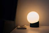 The celestial orb of Gantri’s dimmable Weight table lamp emits a soft, ambient glow.