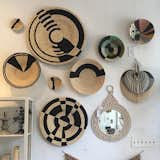 A collection of Kazi woven baskets and walls plates from Uganda at Peace and Riot.