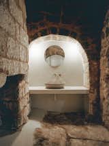 One of the bathrooms features original stone floors, as well as a series of arches and niches.