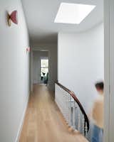 After: By moving the doorway to the closet and bathroom into the primary bedroom, the hallway is now clutter-free, and a reworked layout allows for a floor-through vantage from either end.
