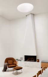The sculptural chimney breast and 60-inch void skylight accentuate the height of the room.