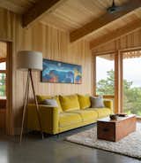 A mustard yellow velvet sofa holds court in the living space where an antique pine trunk serves as a coffee table.