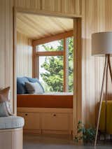 The sleeping nook consists of a built-in platform bed on a bank of drawers. In here, the ceiling dips down to create a more intimate space.