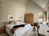 A trio of original artworks by Andrea hang above the Rejuvenation bed in the primary bedroom. A pair of Industry West Cane Wardrobes provide storage.