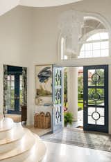 Grand French blue entry doors with a beautiful Turkish area rug.
