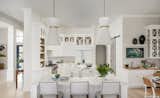 White cabinets and quartz countertops create an elegant kitchen.