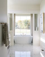 A luxurious free-standing tub creates a stunning focal point.