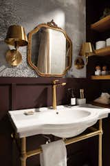 Jewel tones and brass fixtures create an elegant appeal