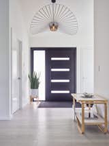 Inviting entryway with elegant light fixture and minimalist decor