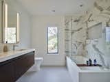Neutral-themed palette and elegant tiles create serene bathroom