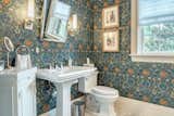 Intricate wallpaper and stylish fixtures adorn the bathroom
