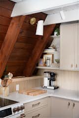 Track lighting and sconces provide additional light