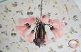 Overhead, a pink chandelier adds drama and delight to the ceiling