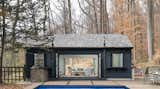 Dark-grey exterior and fully operable doors create seamless flow
