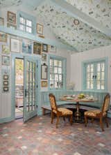 Soft blue-green banquette framed by calming, elegant wall art