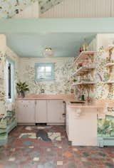 Brass, marble, and mural details elevate this bespoke kitchenette