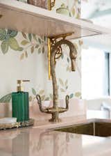 Custom-made brass swan faucet adds a unique charm to the kitchen