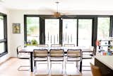 Custom walnut and resin river table with cesca chairs
