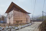 Exterior, Wood Siding Material, Gable RoofLine, Shingles Roof Material, and House Building Type  Photo 1 of 11 in Interlocking Trees Support the Roof of This South Korean Home from The House of Three Trees