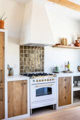 An iridescent Clé Tile backsplash in the kitchen catches the light.