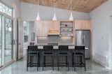 Kitchen, Concrete Floor, Refrigerator, Wood Cabinet, Pendant Lighting, and Ceramic Tile Backsplashe  Photo 12 of 18 in Sapphire Cabin by Rusafova Markulis Architects