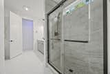 The entryway to Bathroom One, with custom tiled shower.