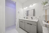 The double vanity in Bathroom One, featuring a touchscreen smart mirror, where you can watch TV or listen to music.