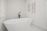 The large soaker tub in Bathroom One across from the double vanities.