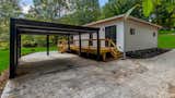 The rear of the FUTRHOMES QUANTUM has a custom 18' wide aluminum carport with louvered sides and roof.