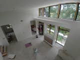 Living Room, Ceiling Lighting, and Porcelain Tile Floor  Photo 19 of 21 in Hillside House by Garrett Cook