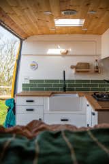 A Belfast sink adds a farmhouse feel to the polished kitchen.   Photo 16 of 22 in Budget Breakdown: A Climbing Couple Turn a Delivery Van Into an Adventure Mobile for $8.5K