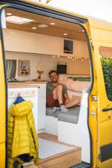 The living room can easily be transformed into a dining area thanks to a pull-out table.  Photo 19 of 22 in Budget Breakdown: A Climbing Couple Turn a Delivery Van Into an Adventure Mobile for $8.5K