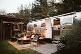 The family omitted a bathroom in the trailer and instead set the trailer beside an outhouse, giving them more living space in the Airstream.  Photo 3 of 11 in 5 Undeniably Cool Projects Built by Designers and Their Dads